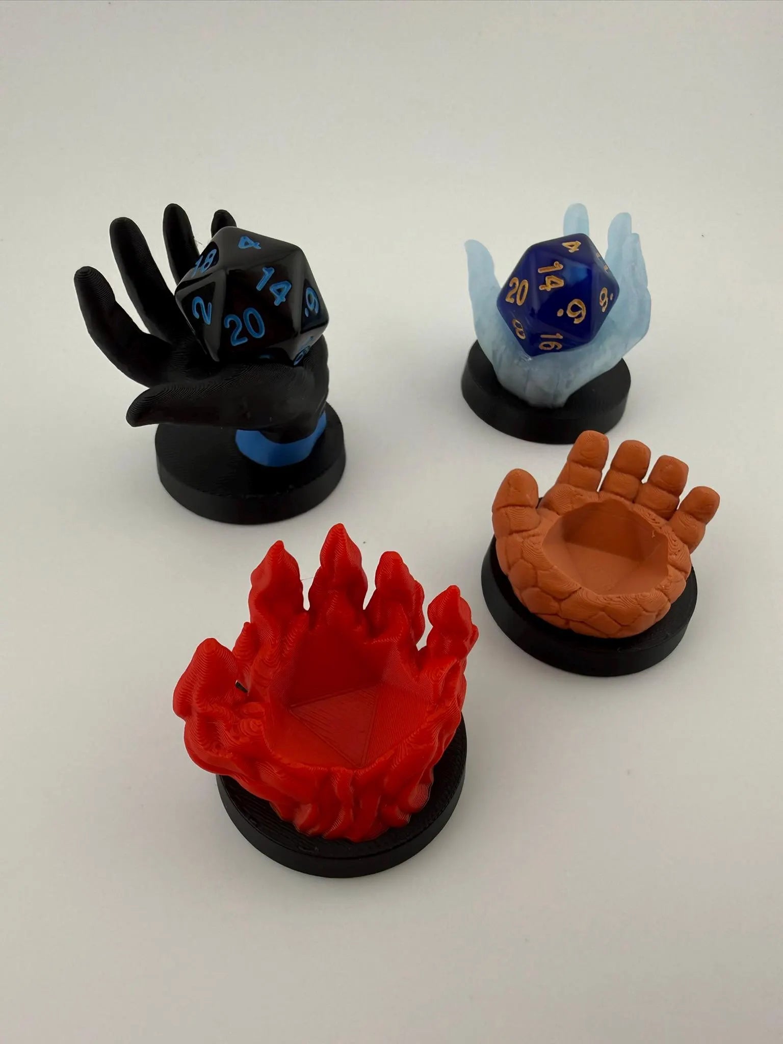 Four Fantastic Dice Holder Hands inspired by the new Magic X Marvel Crossover
